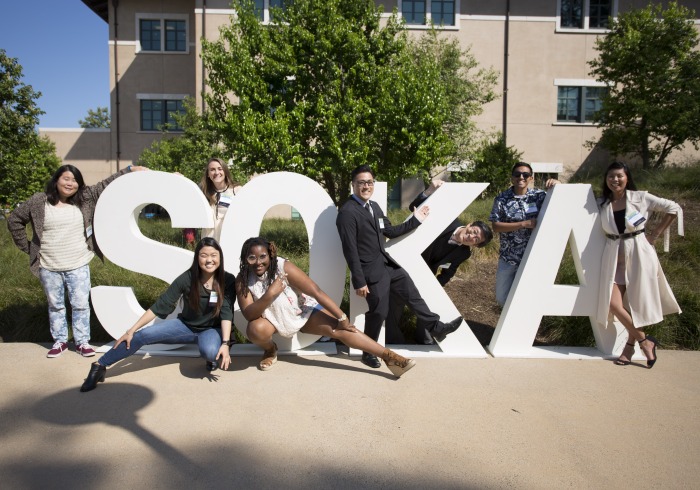 Alumni around Soka sign