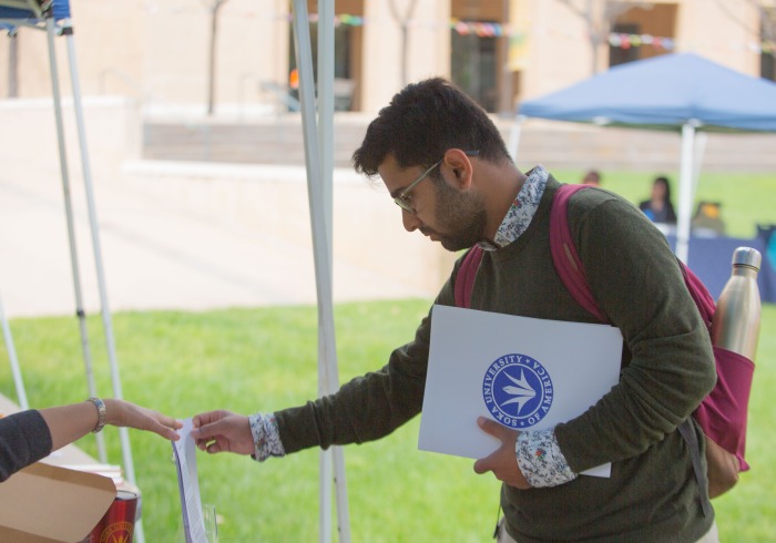 student receiving flyer at career fair