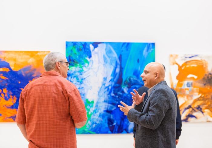 Image of two visitors discussing at the art gallery.