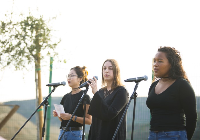 Image of students performing in garden