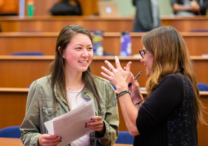 Image of faculty speaking with student