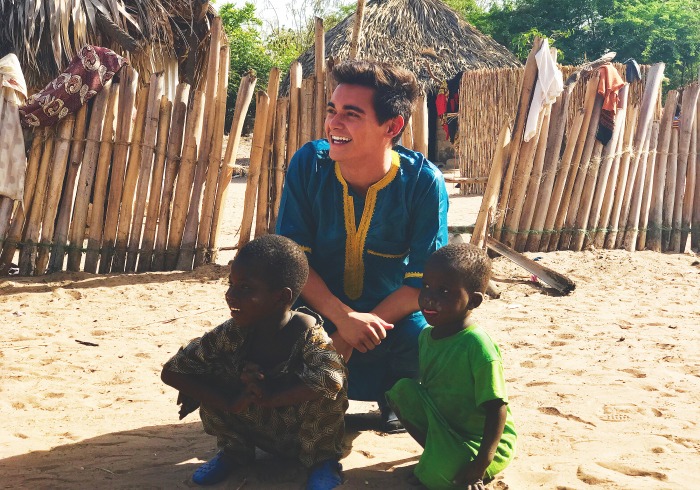 Image of student with two children in Dakar, Senegal.