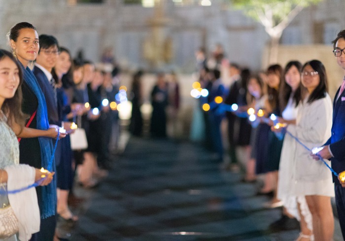 Image of students holding lights along the Peace Walk.