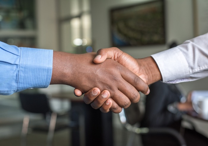 Close-up image of two people shaking hands.