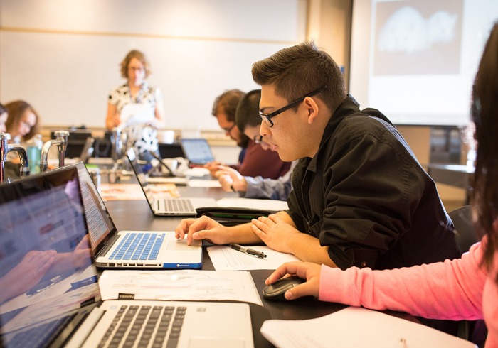 Students working on laptops in Pauling Hall classroom