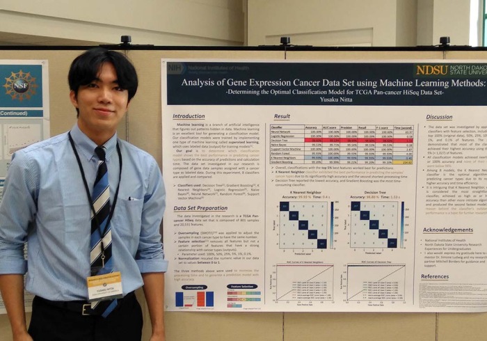 Person stands next to machine learning methods poster