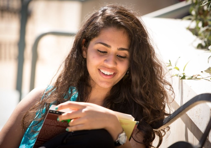 Student reading on campus