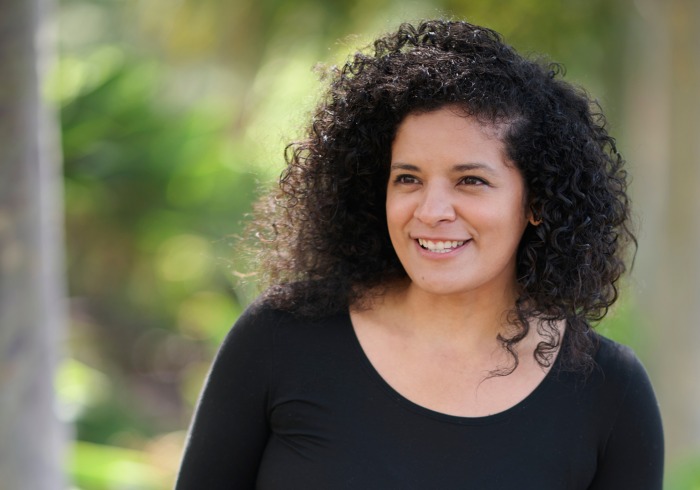 Jacqueline Cid poses outside wearing a black shirt for the Women of SUA photoshoot