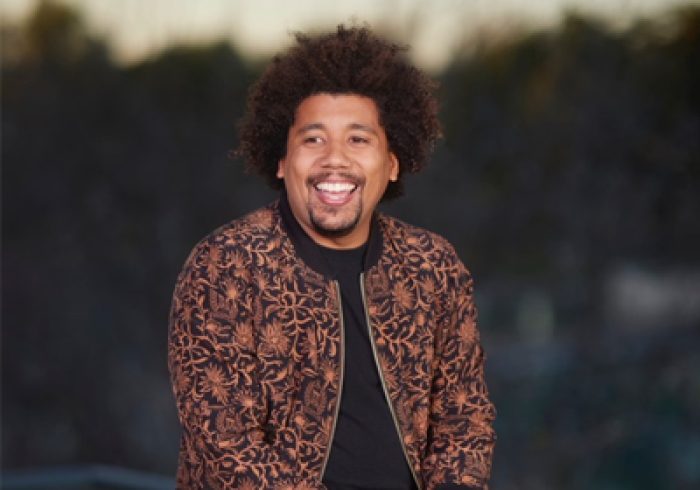 Avelino Pitts smiles as he sits outside on Soka's Campus