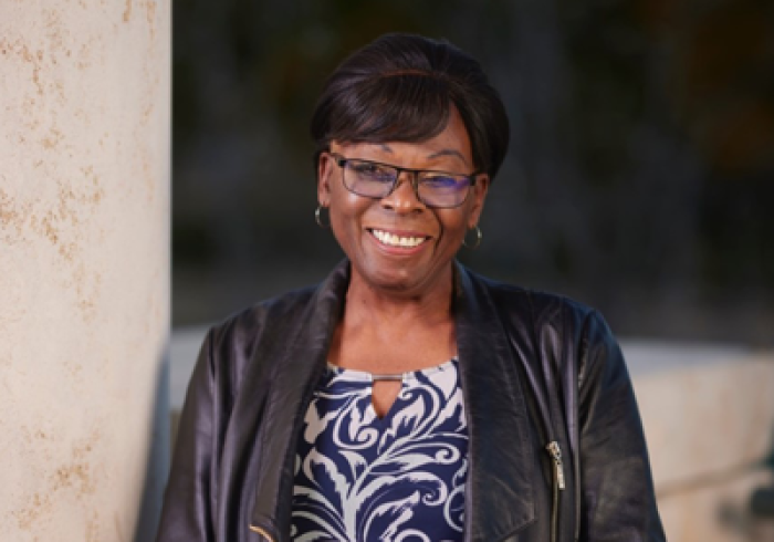 Teri Chester smiles as she stands outside on Soka's Campus