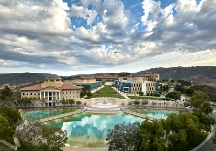 Exterior drone shot of Soka University of America's campus with blue sky and fluffy white clouds