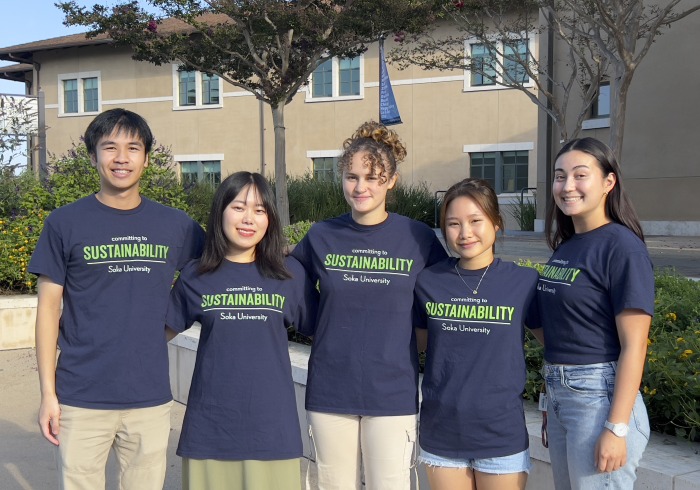 5 student members of the Sustainability Committee pose for a photo outdoors on Soka's campus.