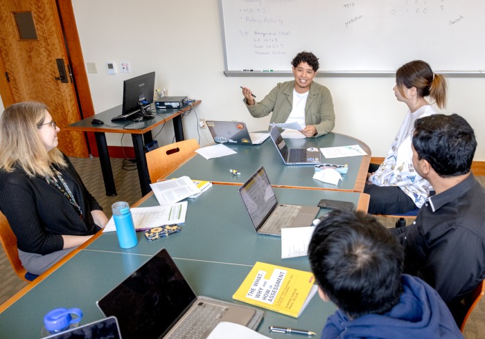 Professor instructs four graduate students in a typically intimate Soka class