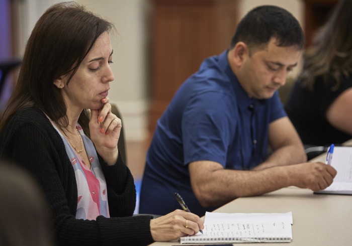 Attendees of the conference listen intently during a discussion