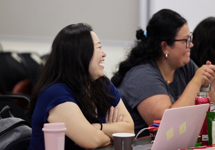 Conference attendees laugh during a discussion