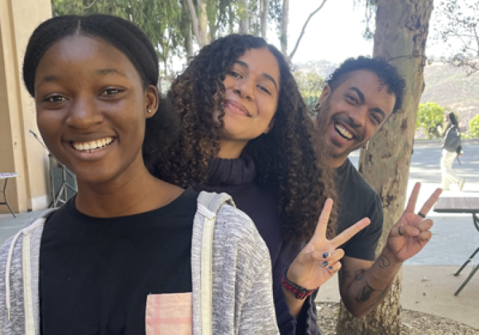 Members of the DEI Staff pose for a photo on campus