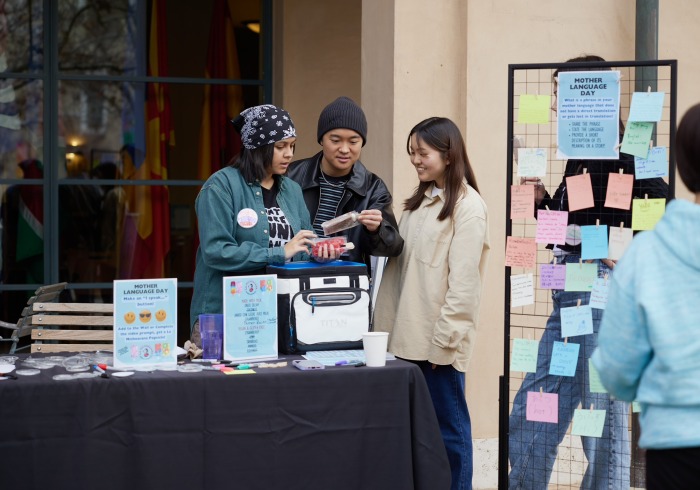 DEI Student employees speak amongst themselves during a campus event.