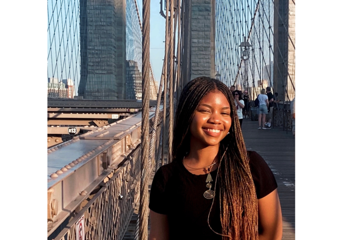 Woman smiling with bridge in the background