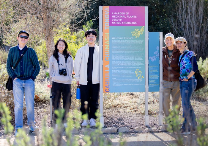 A small group of undergraduate students from the "Geo-storytelling Ballona" Learning Cluster pose at the Ballona Wetlands