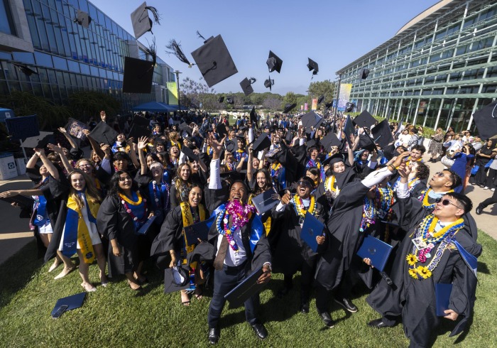 Students throwing graduation caps.