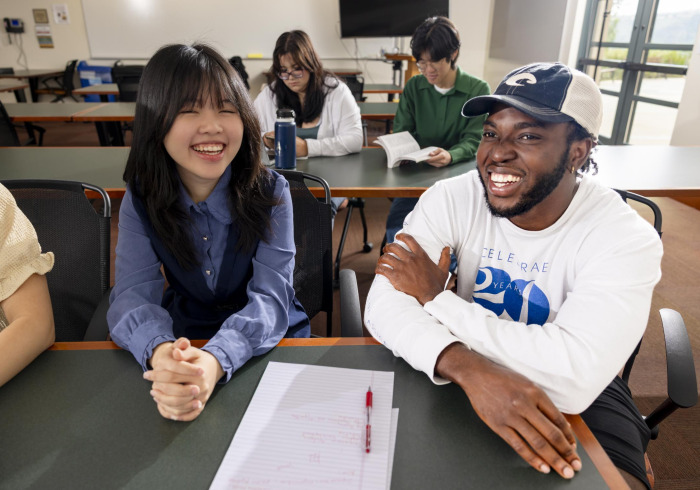 Students smile in the classroom.