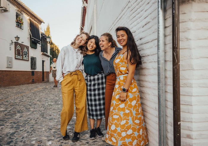 Four students pose together outside during a study abroad trip.