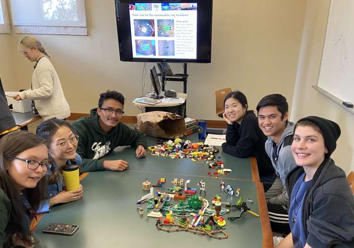Student work with lego pieces to build a sustainable city.