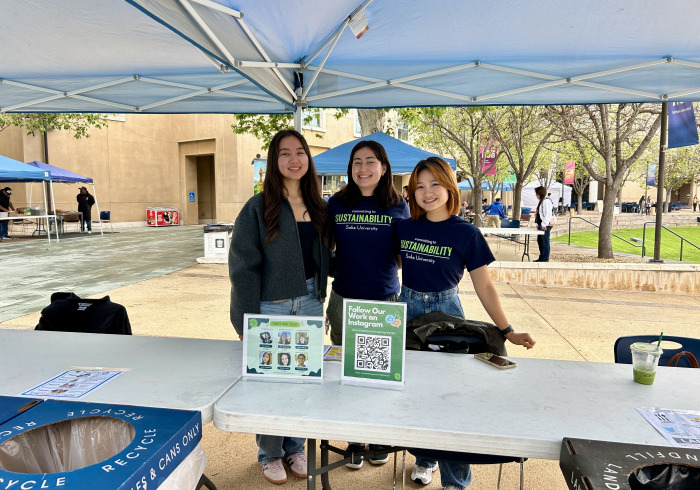 Photo of three Sustainability Educators at an event
