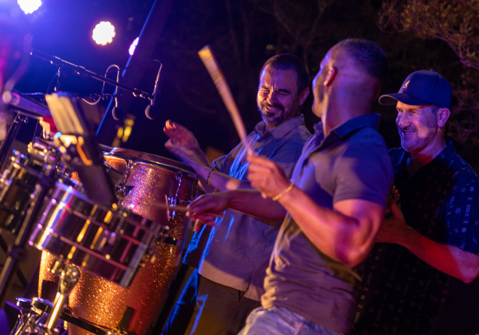 Musicians smile as they perform