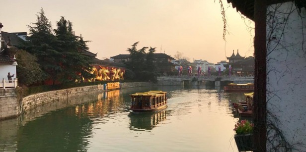 Buildings on either side of a river in Nanjing, China