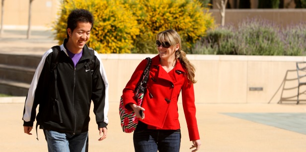 Image of two students walking around campus.