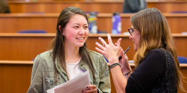 Image of faculty speaking with student