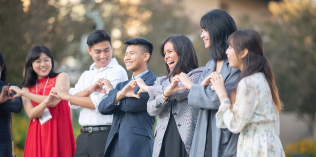 Image of students making hearts with their hands