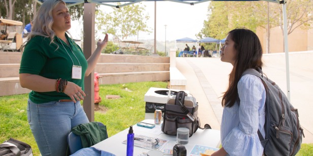 Image of a student speaking to employer at Career Fair.
