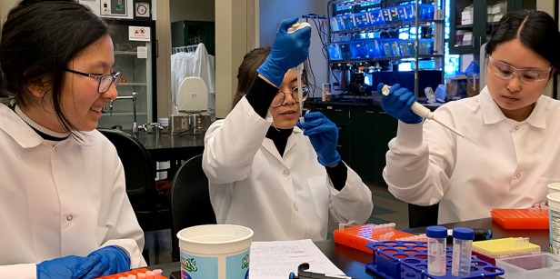 Three students working in science lab