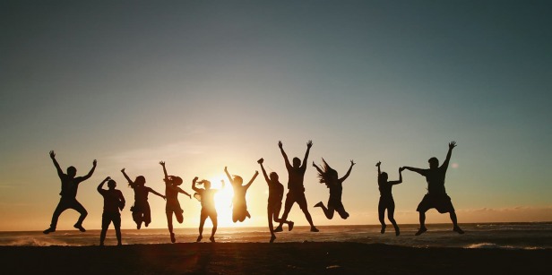 Silhouettes of a group of people jumping  