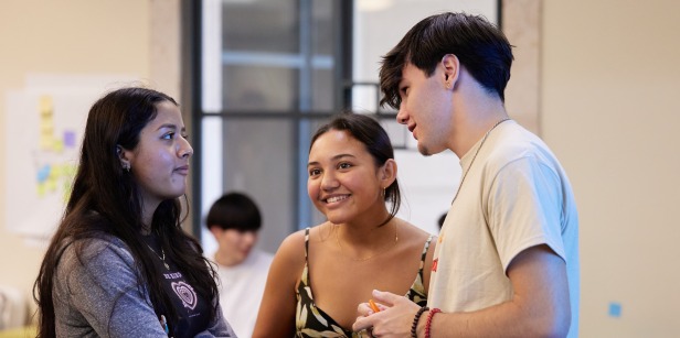Three Soka students are happily having a conversation