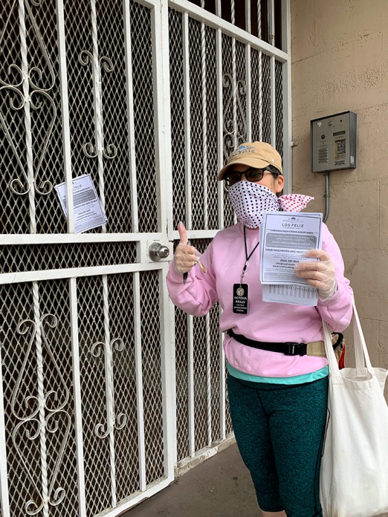 Victoria Kraus hangs an info flyer in her neighborhood 