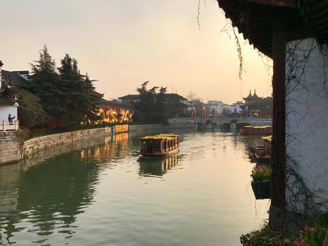 Buildings on either side of a river in Nanjing, China