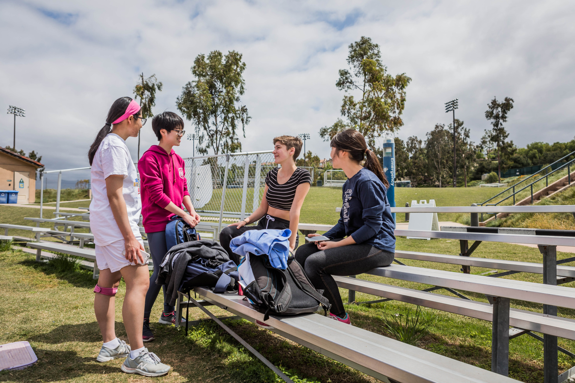 Image of students chatting by the track.