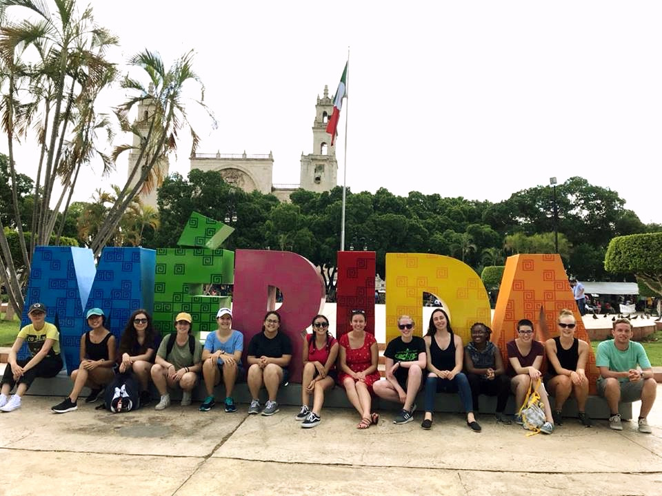 Students in front of letters spelling out Merida