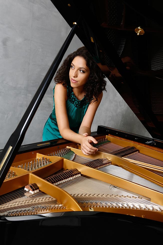 Beatrice Rana leaning on piano