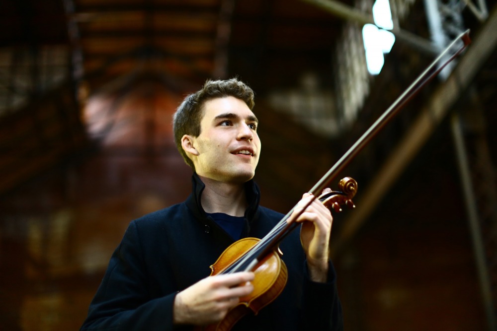 Alexi Kenney holding violin