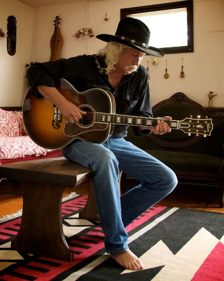 Arlo Guthrie playing guitar
