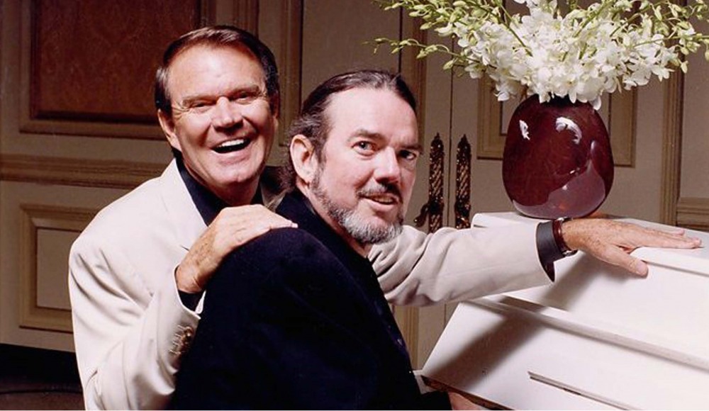 Glen Campbell and Jimmy Webb sitting at piano