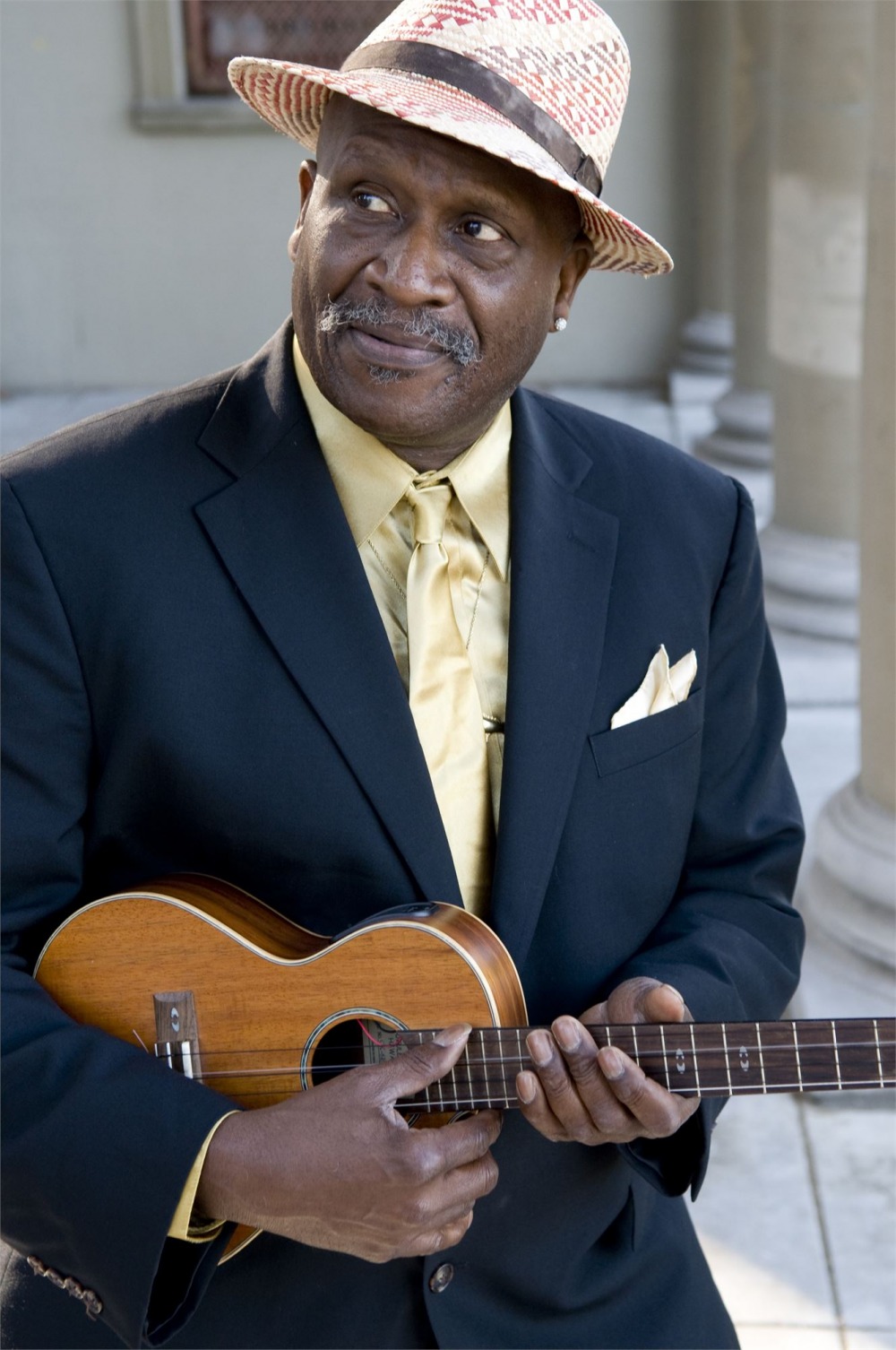 Taj Mahal holding acoustic guitar