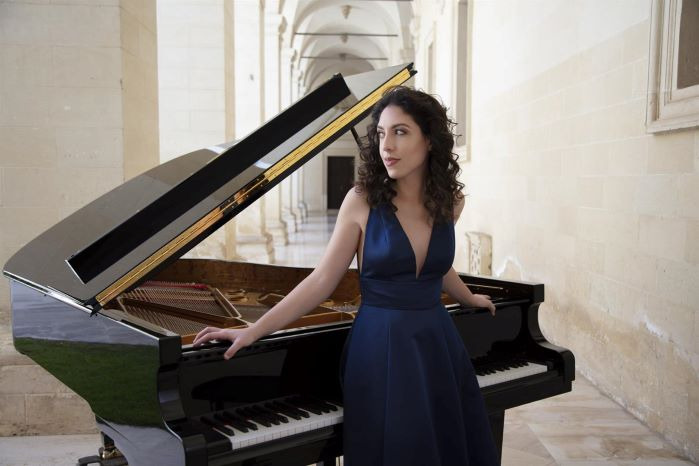 Beatrice Rana standing at piano
