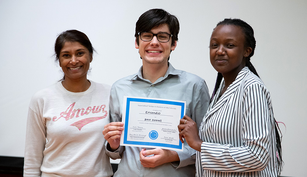 Lucas Caceres, Linda Mutesi, and Shaheen Sheik-Sadhal holding award