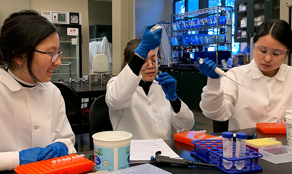 Three students working in science lab