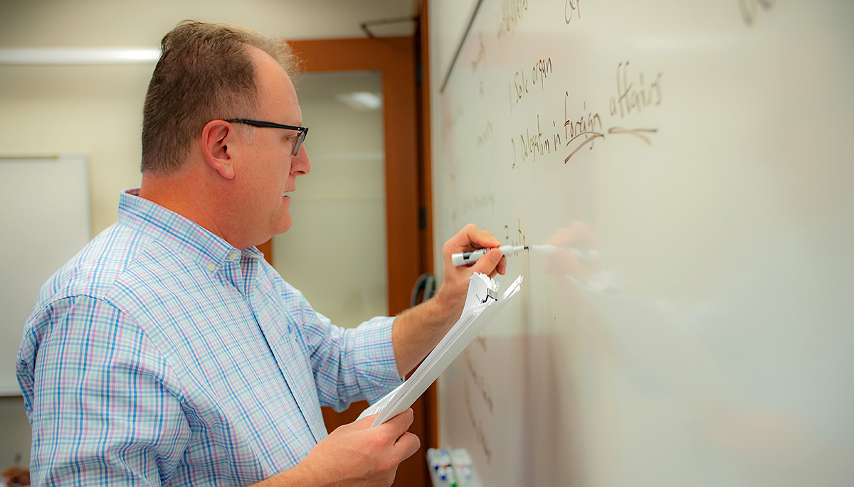 Peter Burns writes on a whiteboard
